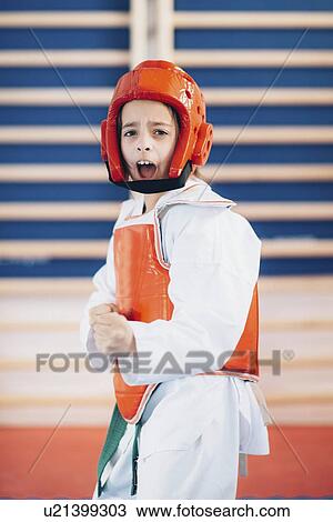 Stock Image - Girl in taekwondo class. Fotosearch