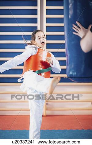 Girl kicking punching bag View Large Photo Image Stock Image - Girl kicking punching bag. Fotosearch