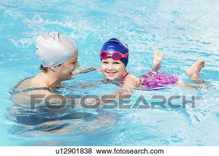 Stock Photo - Girl learning to swim. Fotosearch