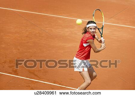 Stock Image - Girl playing tennis. Fotosearch