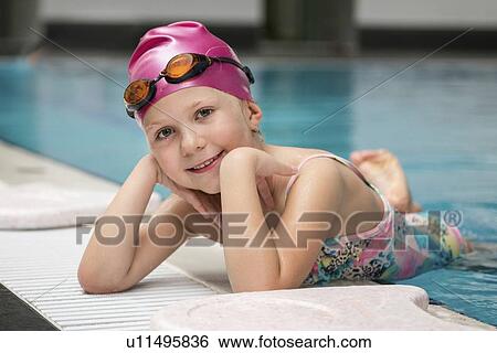 Girl posing on swimming pool edge View Large Photo Image Stock Photograph - Girl posing on swimming pool edge. Fotosearch