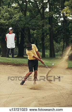 Golfer playing from bunker View Large Photo Image Stock Image - Golfer playing from bunker. Fotosearch
