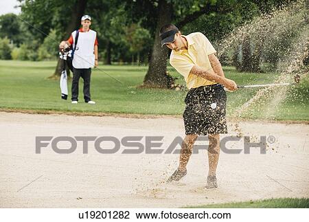 Golfer playing from sand trap View Large Photo Image Stock Image - Golfer playing from sand trap. Fotosearch