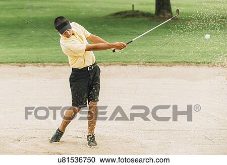 Stock Image - Golfer Playing From Sand Trap. Fotosearch