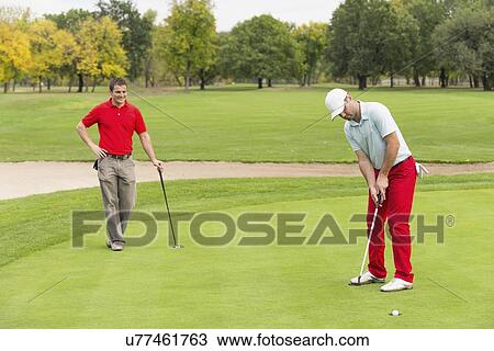 Golfers on the green View Large Photo Image Stock Image - Golfers on the green. Fotosearch