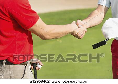 Stock Image - Golfers shake hands. Fotosearch