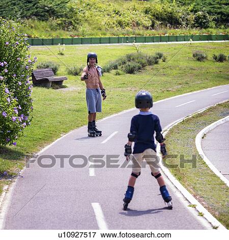 Grandfather and grandson roller skating View Large Photo Image Stock Photo - Grandfather and grandson roller skating. Fotosearch