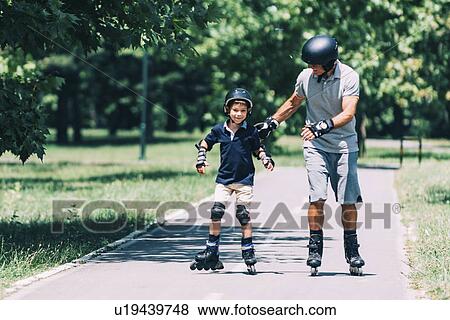 Stock Photo - Grandfather and grandson roller skating. Fotosearch