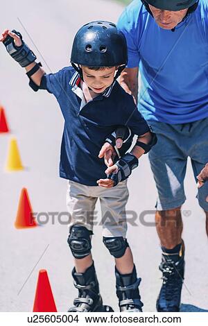 Grandfather teaching grandson to roller skate View Large Photo Image Picture - Grandfather teaching grandson to roller skate. Fotosearch