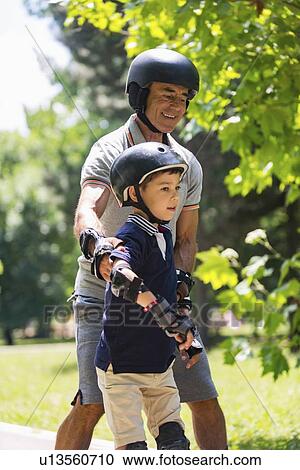 Grandfather teaching grandson to roller skate View Large Photo Image Stock Image - Grandfather teaching grandson to roller skate. Fotosearch