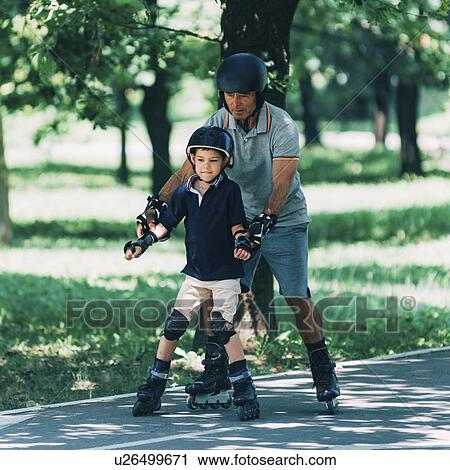 Grandfather teaching grandson to roller skate View Large Photo Image Stock Image - Grandfather teaching grandson to roller skate. Fotosearch