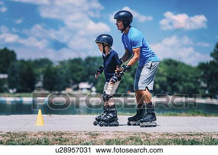 Stock Image - Grandfather teaching grandson to roller skate. Fotosearch