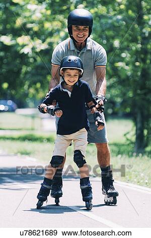 Grandfather teaching grandson to roller skate View Large Photo Image Stock Photo - Grandfather teaching grandson to roller skate. Fotosearch