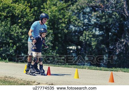 Grandfather teaching grandson to roller skate View Large Photo Image Stock Photography - Grandfather teaching grandson to roller skate. Fotosearch