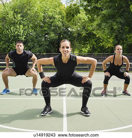 Stock Image - Group exercise class outdoors. Fotosearch
