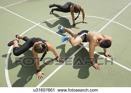 Stock Image - Group exercising outdoors. Fotosearch