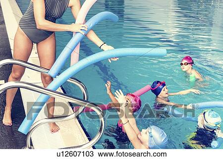 Stock Image - Group swimming lesson. Fotosearch