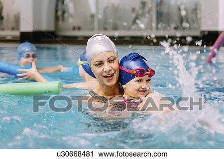 Stock Image - Group swimming lesson. Fotosearch