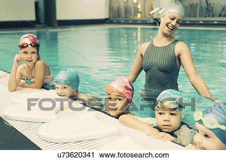 Stock Image - Group swimming lesson. Fotosearch