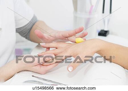 Stock Photograph - Hand cream application during manicure. Fotosearch