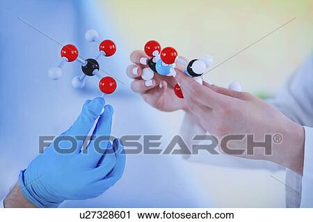 Stock Image - Hands holding molecular structure. Fotosearch