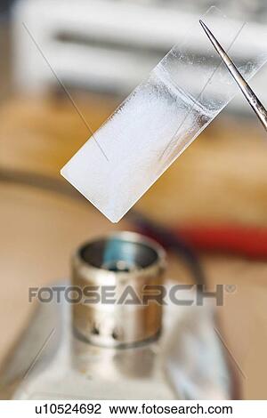 Holding microscope slide over flame View Large Photo Image Stock Image - Holding microscope slide over flame. Fotosearch