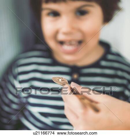 Picture - Homeopath giving remedy to child. Fotosearch