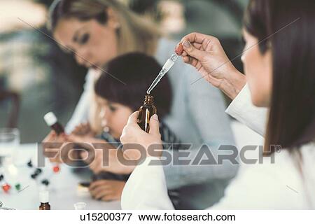 Stock Photo - Homeopath giving remedy to child. Fotosearch