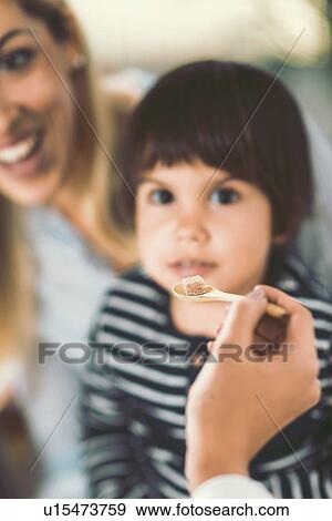 Stock Photo - Homeopath giving remedy to child. Fotosearch