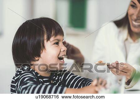 Stock Photograph - Homeopath giving remedy to child. Fotosearch