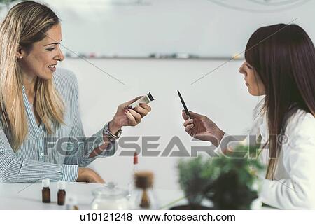 Stock Photo - Homeopath giving remedy to woman. Fotosearch