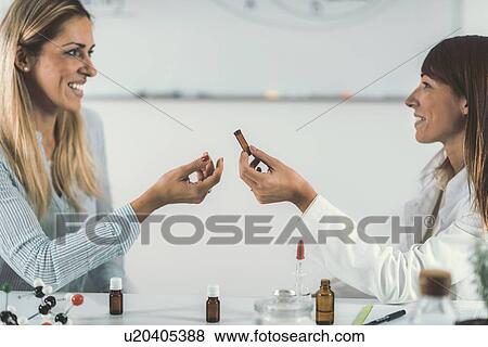 Stock Photo - Homeopath giving remedy to woman. Fotosearch