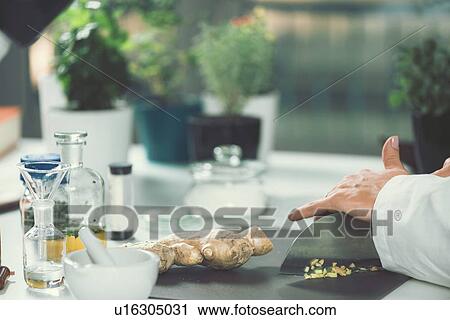 Stock Image - Homeopath preparing herbal remedies. Fotosearch