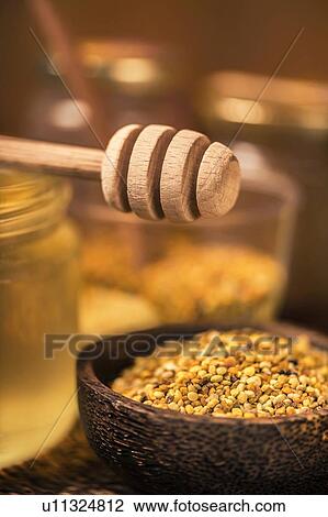 Honey dipper and honey bee pollen in wooden bowl View Large Photo Image Stock Image - Honey dipper and honey bee pollen in wooden bowl. Fotosearch