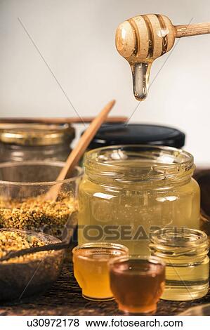Honey flowing into a glass jar View Large Photo Image Stock Photo - Honey flowing into a glass jar. Fotosearch