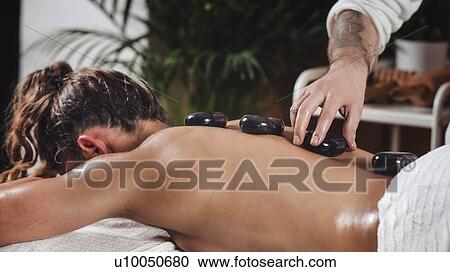 Stock Image - Hot stone massage. Fotosearch