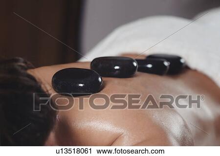 Hot stone massage View Large Photo Image Stock Image - Hot stone massage. Fotosearch