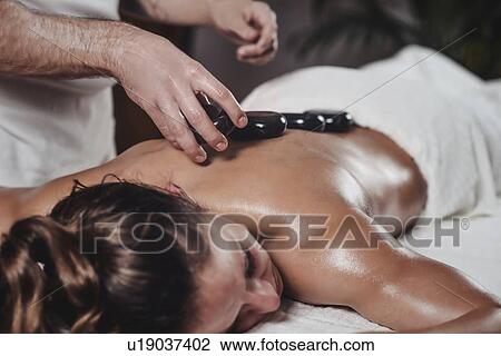 Stock Image - Hot stone massage. Fotosearch