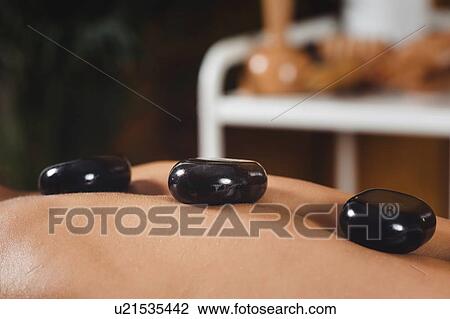 Stock Image - Hot stone massage. Fotosearch