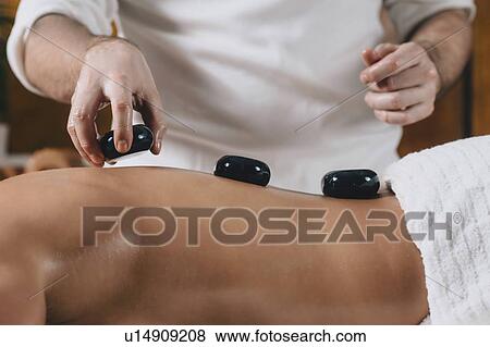 Hot stone massage View Large Photo Image Stock Photo - Hot stone massage. Fotosearch