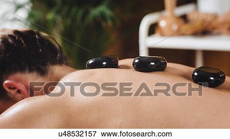 Stock Photo - Hot stone massage. Fotosearch