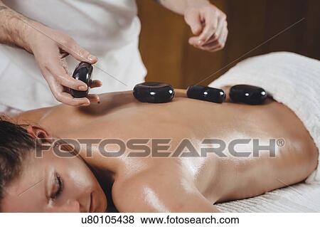 Hot stone massage View Large Photo Image Stock Photo - Hot stone massage. Fotosearch