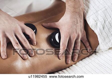 Stock Photography - Hot stone massage. Fotosearch