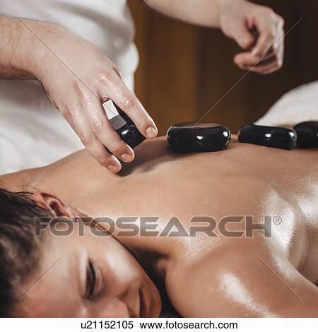 Hot stone massage View Large Photo Image Stock Photography - Hot stone massage. Fotosearch