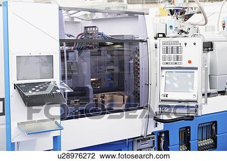 Stock Image - Hydraulic injection moulding machine. Fotosearch