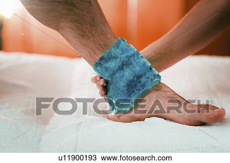 Ice pack on painful ankle View Large Photo Image Stock Image - Ice pack on painful ankle. Fotosearch