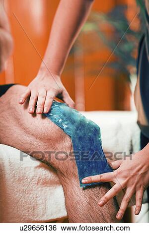 Stock Photograph - Ice pack on painful knee. Fotosearch