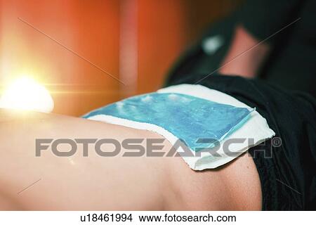 Ice pack on painful lower back View Large Photo Image Picture - Ice pack on painful lower back. Fotosearch