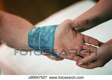 Ice pack on painful wrist View Large Photo Image Stock Photo - Ice pack on painful wrist. Fotosearch