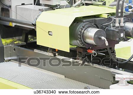 Stock Image - Industrial plastic injection moulding machine. Fotosearch
